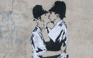 Beg Steal Borrow's video for Extradition Order's 'Boy in Unifirm' takes inspiration from Banksy's famous and controversial mural, Kissing Coppers.